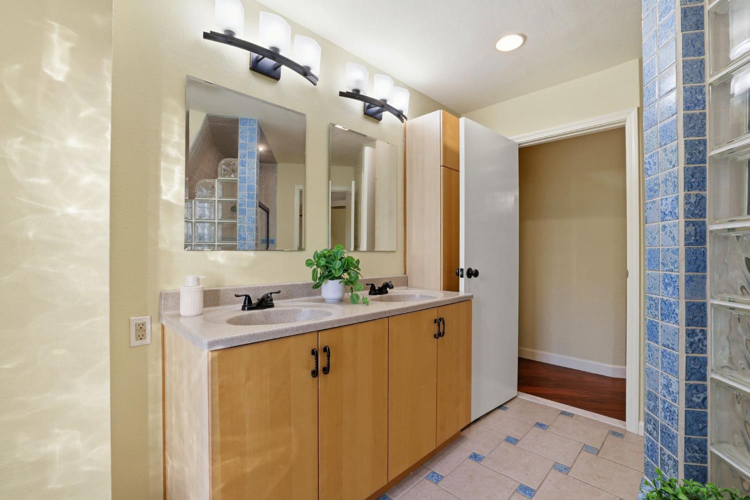 7890 Boren Lane Granite Bay, CA 95746 - Photo 30 of 96 a bathroom with a granite countertop sink mirror and double
