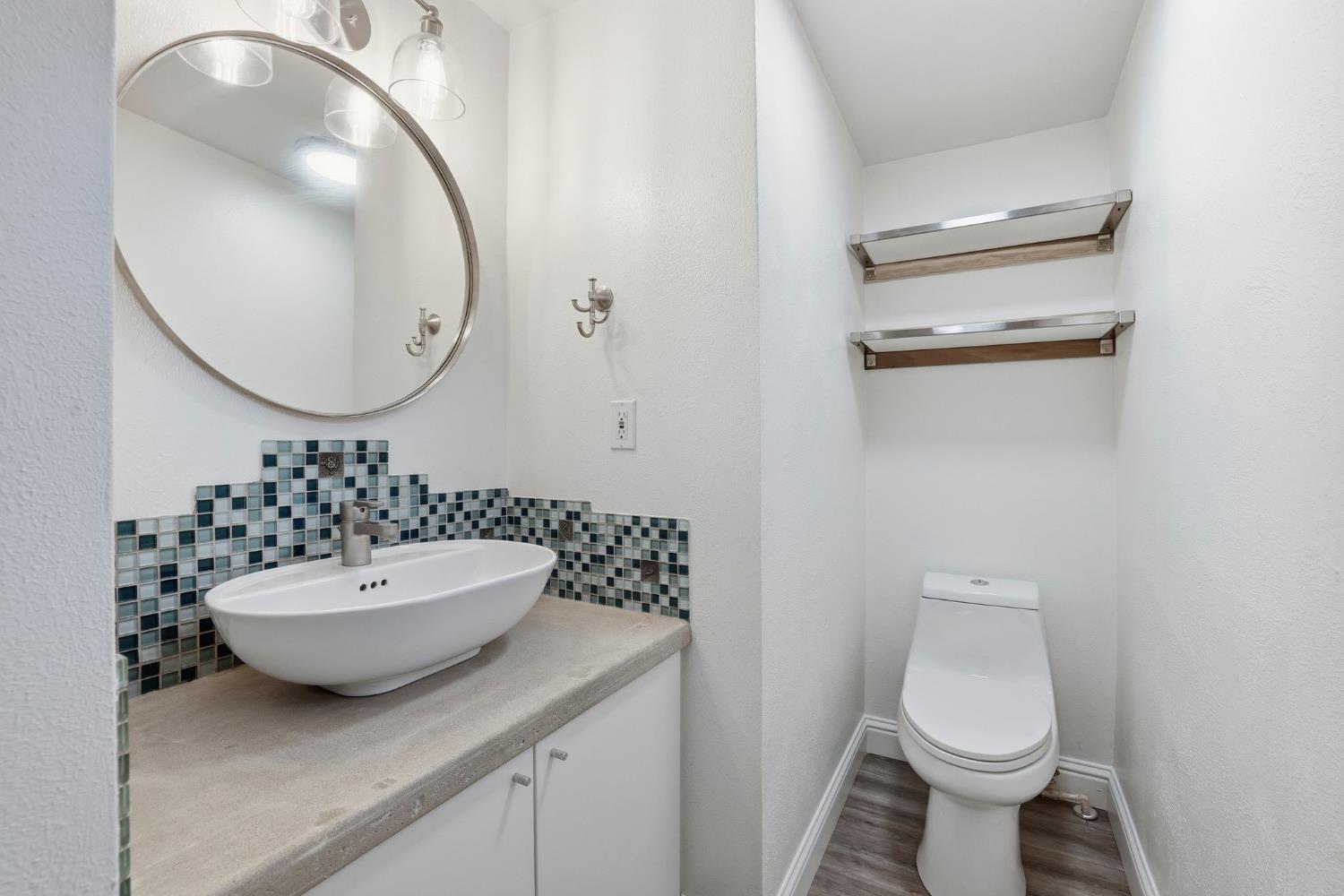 7890 Boren Lane Granite Bay, CA 95746 - Photo 65 of 96 a bathroom with a sink a toilet and a mirror