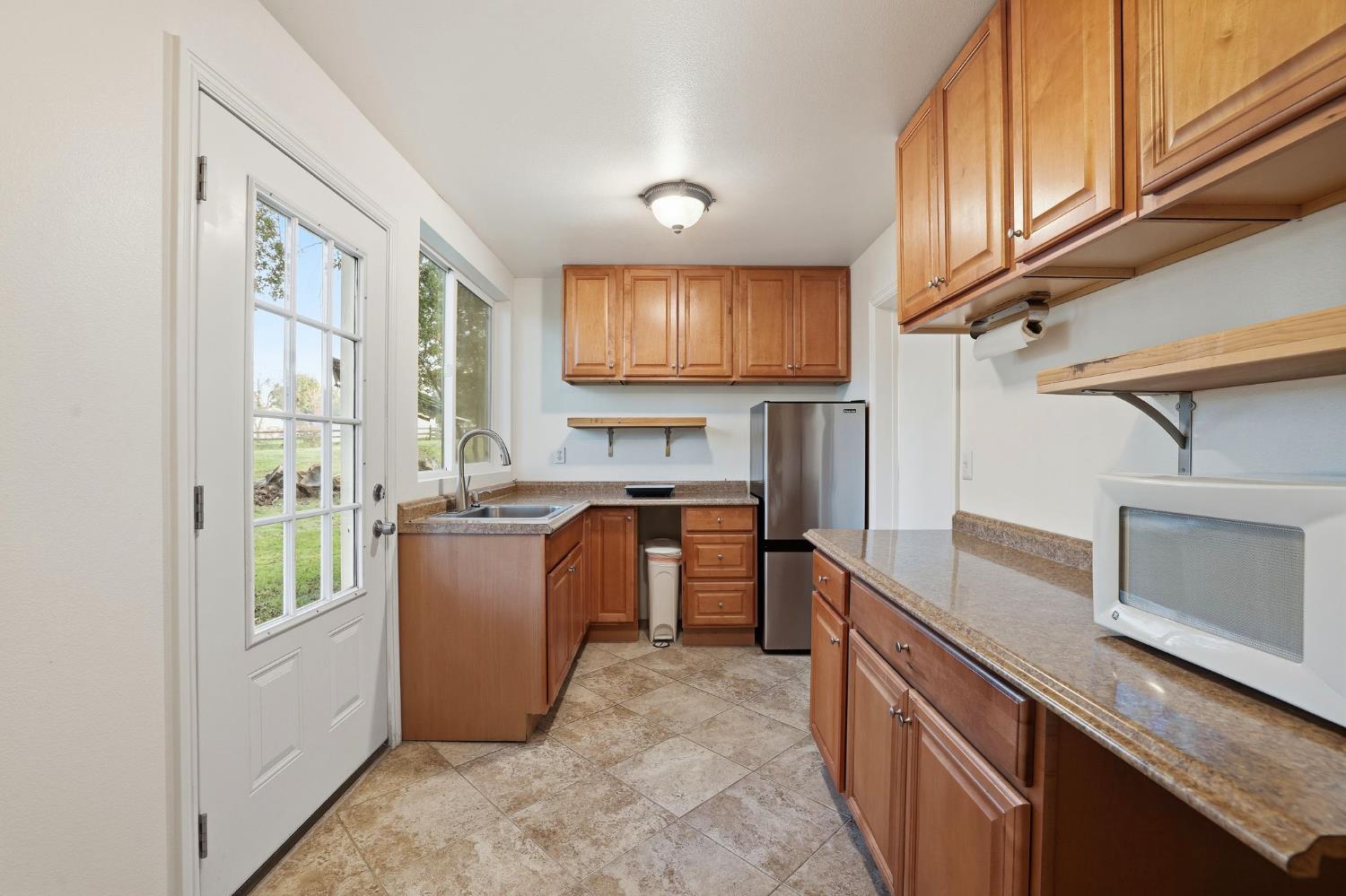 7890 Boren Lane Granite Bay, CA 95746 - Photo 82 of 96 a kitchen with stainless steel appliances granite countertop a stove a sink and a refrigerator