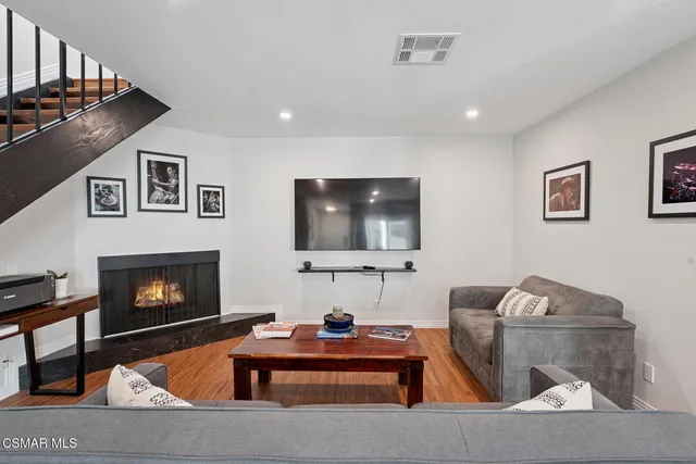 a living room with furniture a fireplace and a table