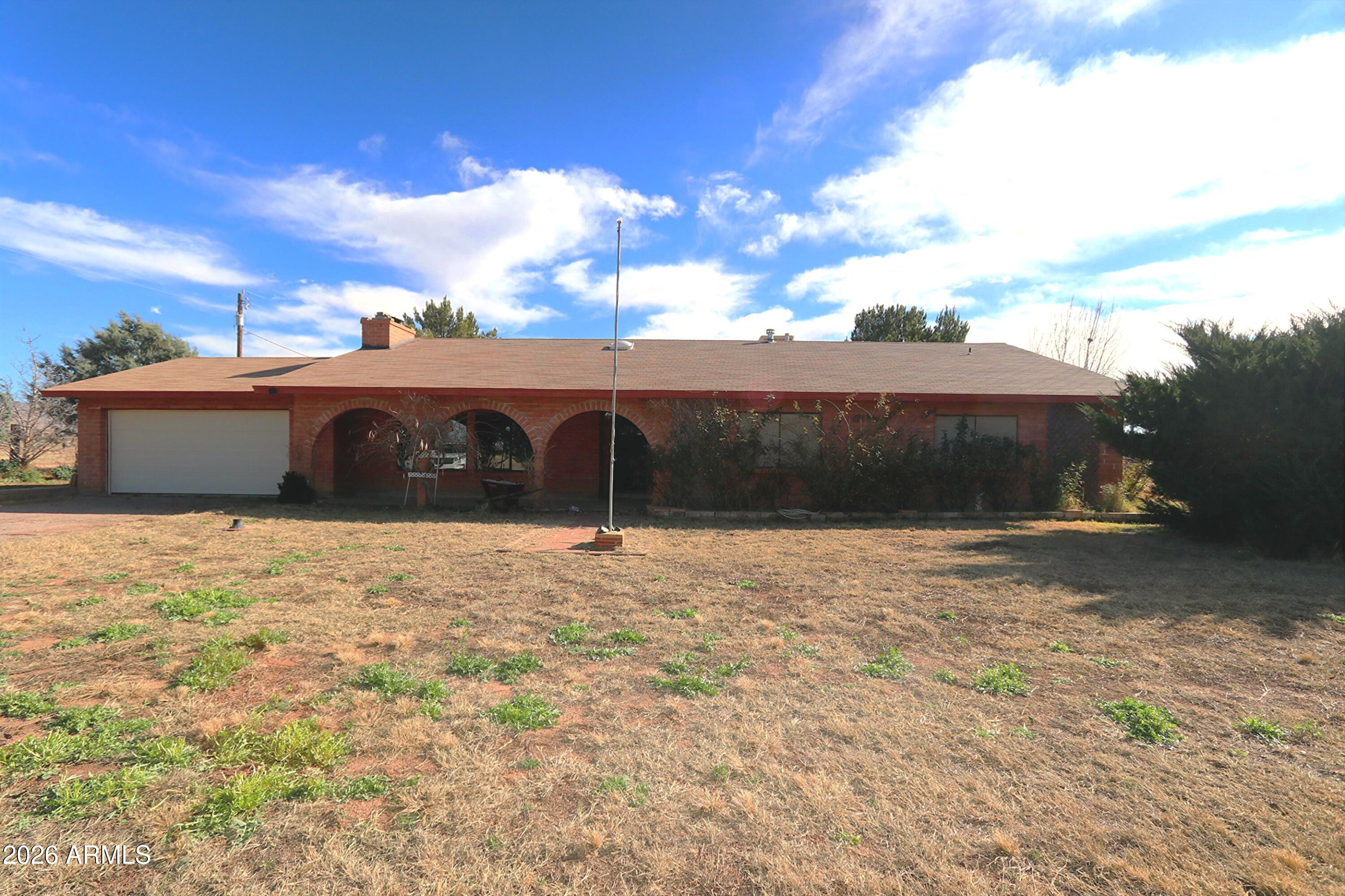 a front view of a house with a yard and a garage