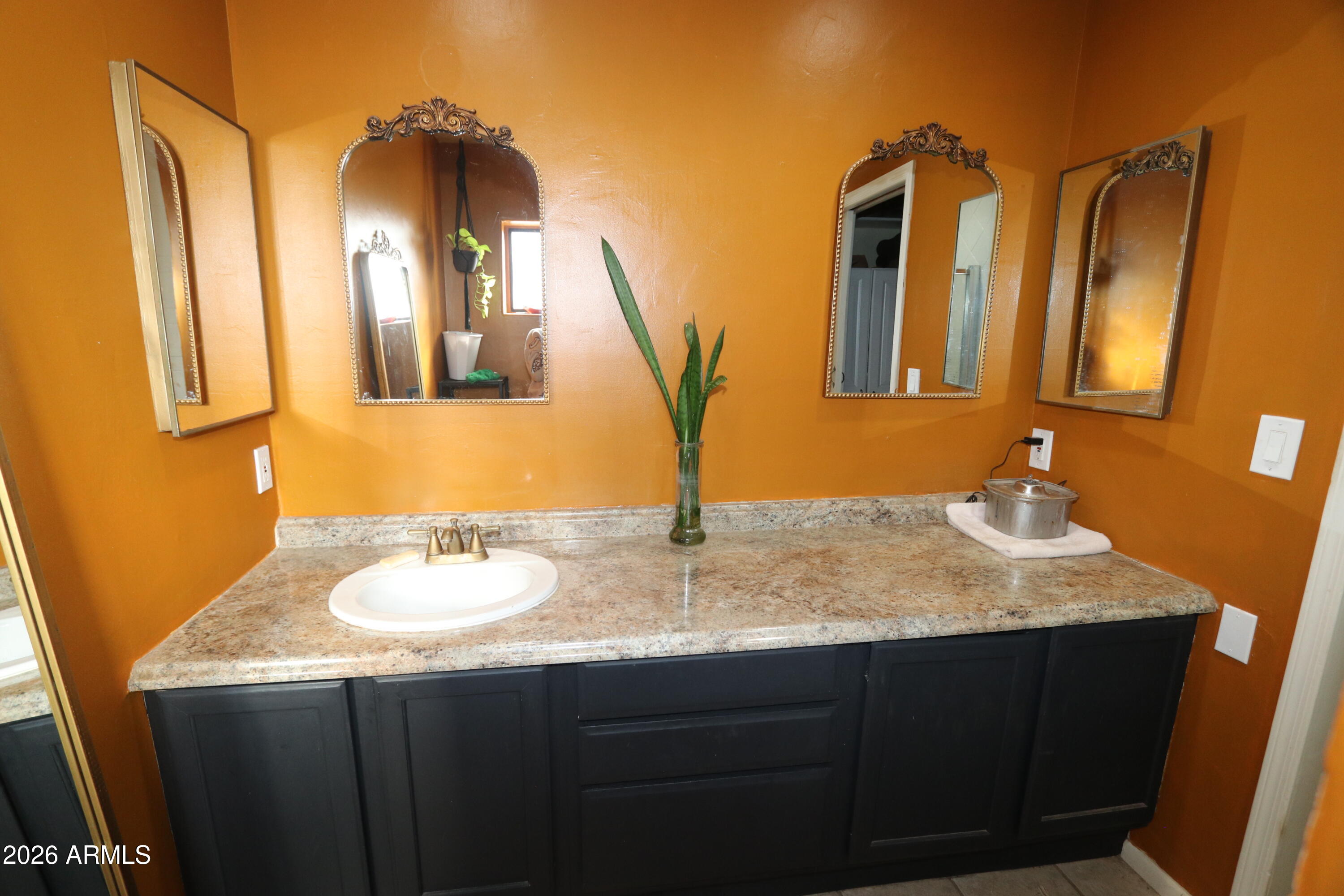 11870 Fort Grant Road Willcox, AZ 85643 - Photo 23 of 44 a bathroom with a granite countertop sink and a mirror