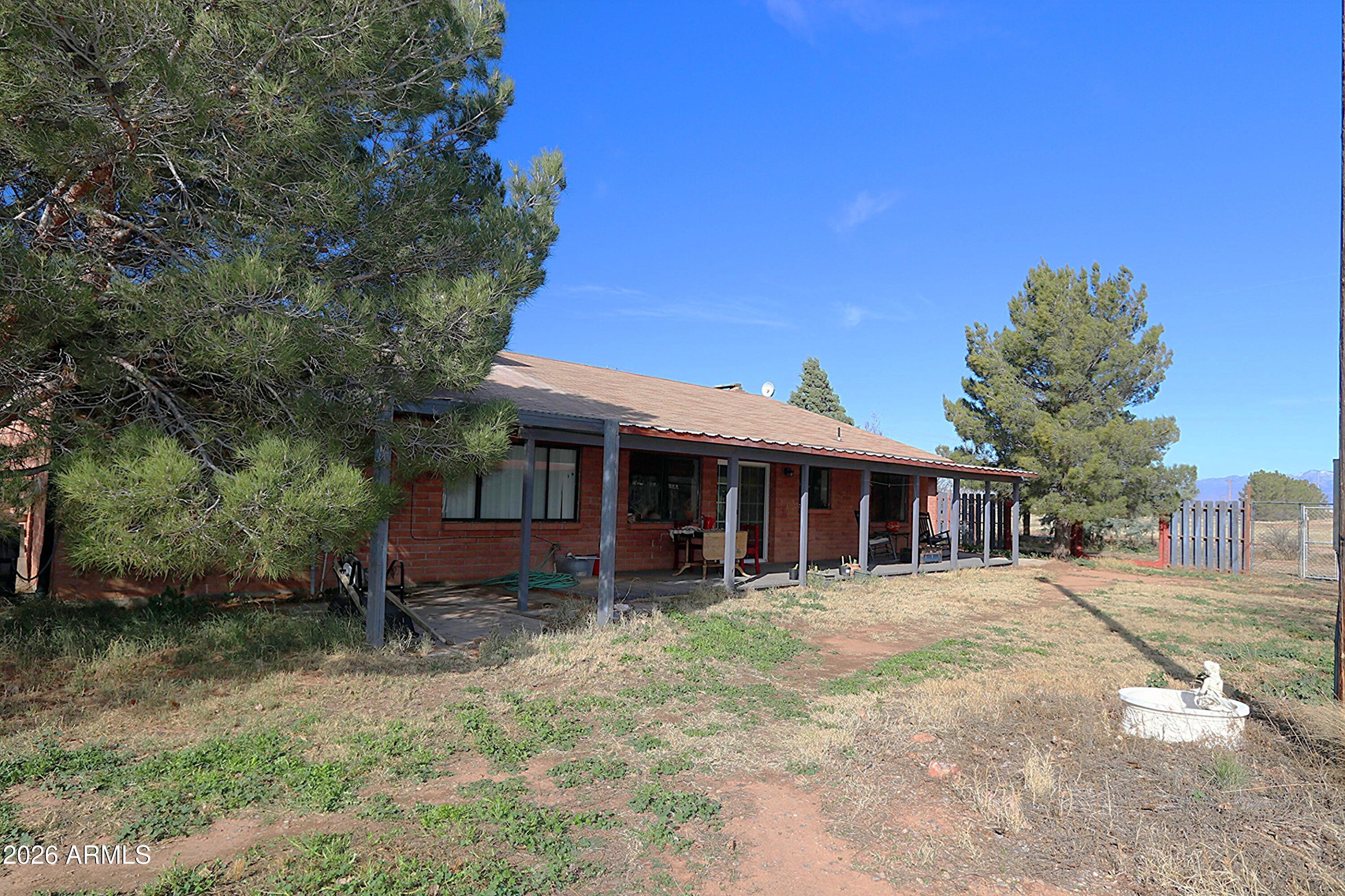 11870 Fort Grant Road Willcox, AZ 85643 - Photo 26 of 44 a front view of a house with a garden