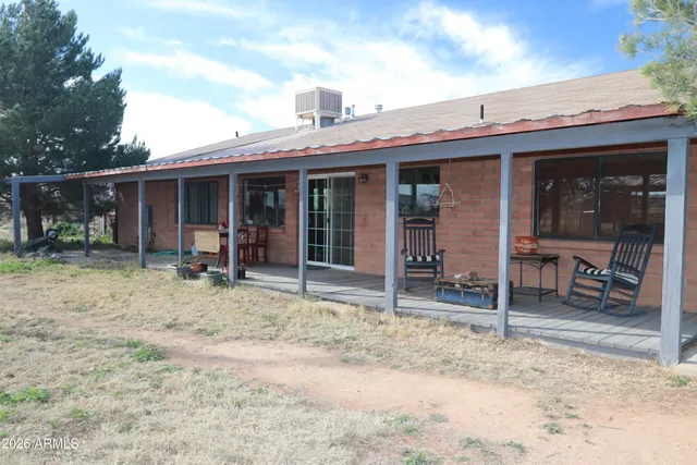 a backyard of a house with plants and outdoor seating