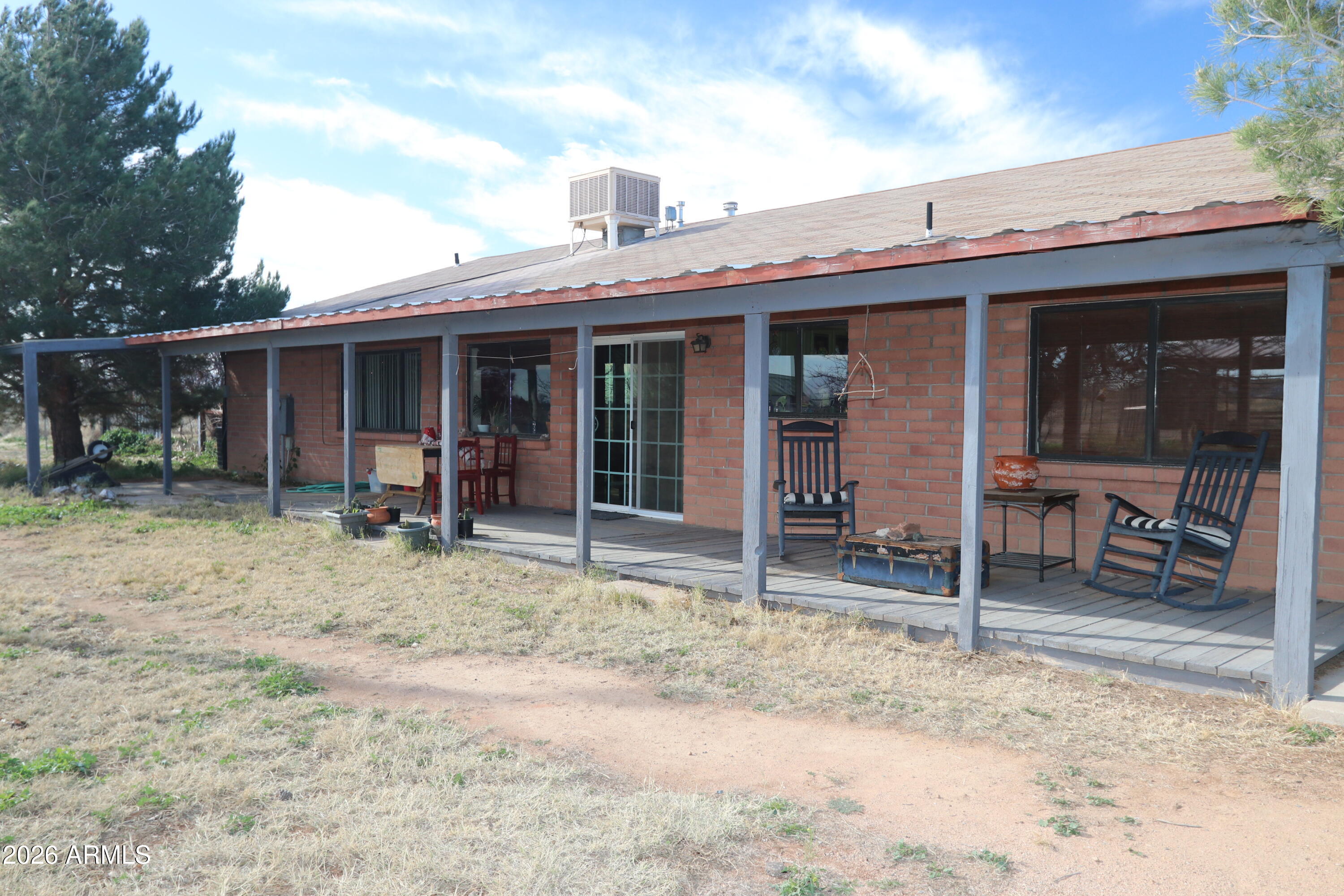 11870 Fort Grant Road Willcox, AZ 85643 - Photo 27 of 44 a view of a house with a backyard and porch