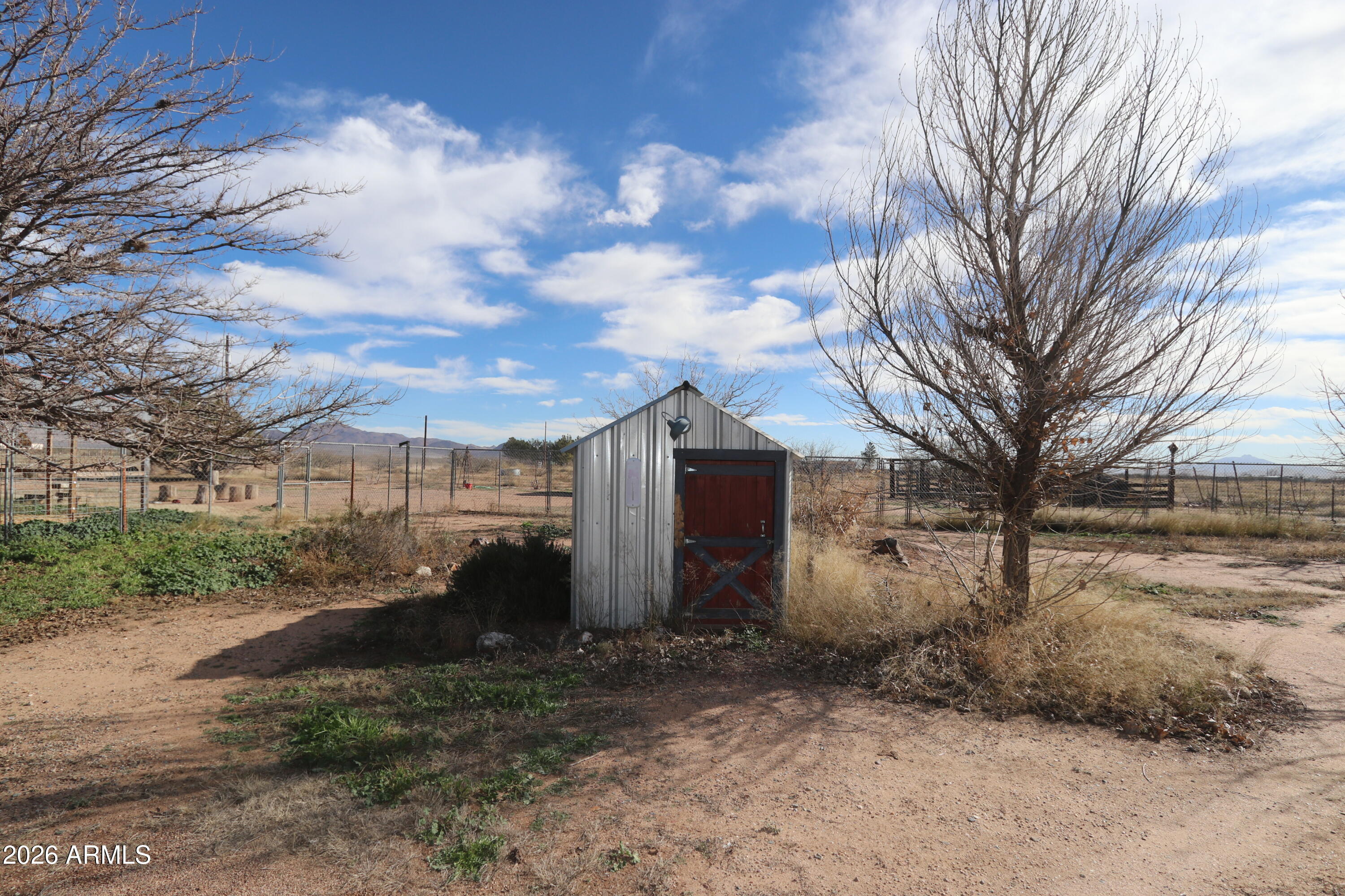 11870 Fort Grant Road Willcox, AZ 85643 - Photo 31 of 44 a view of a grey house with a yard