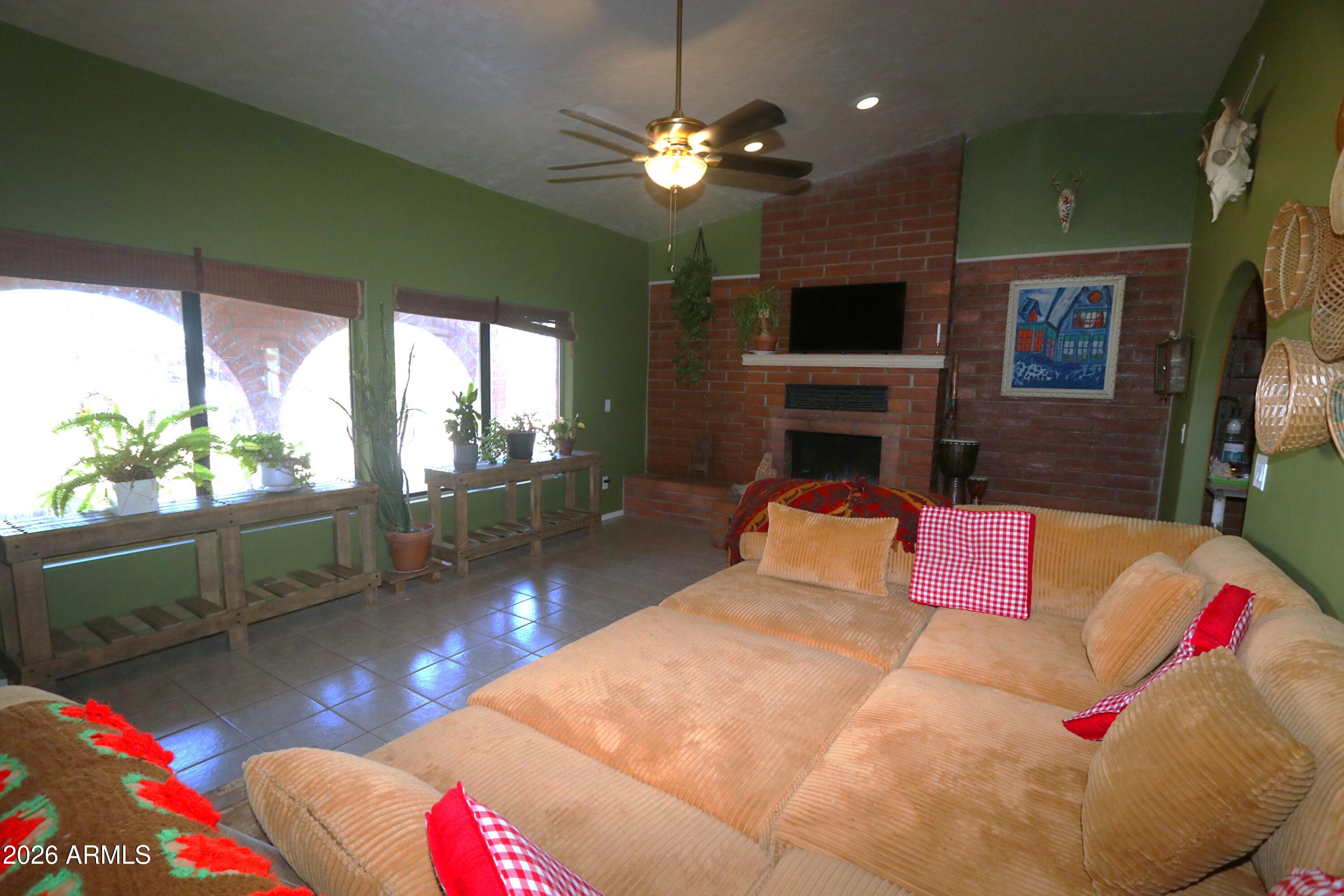 11870 Fort Grant Road Willcox, AZ 85643 - Photo 9 of 44 a living room with furniture and a flat screen tv