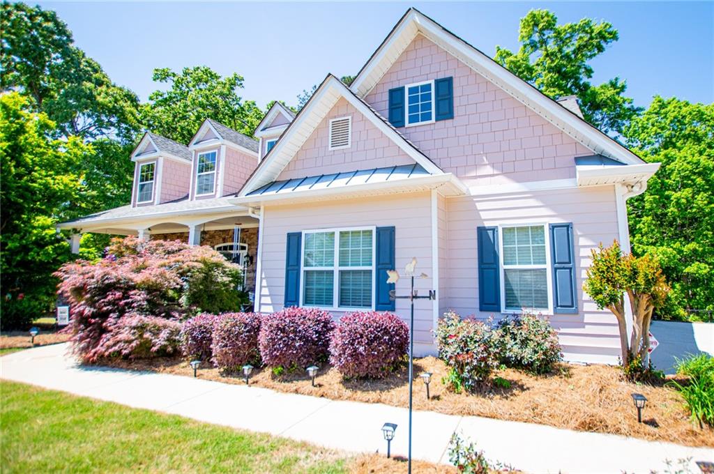 6170 Hedgestone Way Douglasville, GA 30135 - Photo 105 of 106 a front view of a house with a yard and potted plants