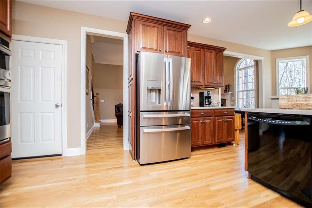 6170 Hedgestone Way Douglasville, GA 30135 - Photo 24 of 106 a kitchen with stainless steel appliances granite countertop a refrigerator a sink dishwasher a stove and a refrigerator with wooden floor