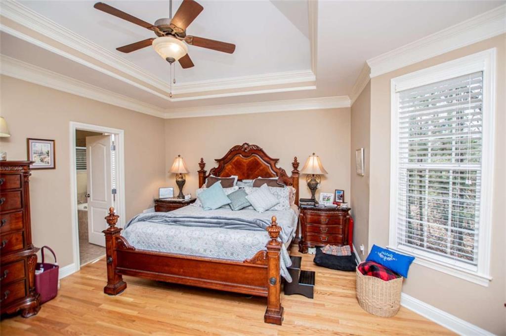 6170 Hedgestone Way Douglasville, GA 30135 - Photo 35 of 106 a bedroom with a bed and a chandelier