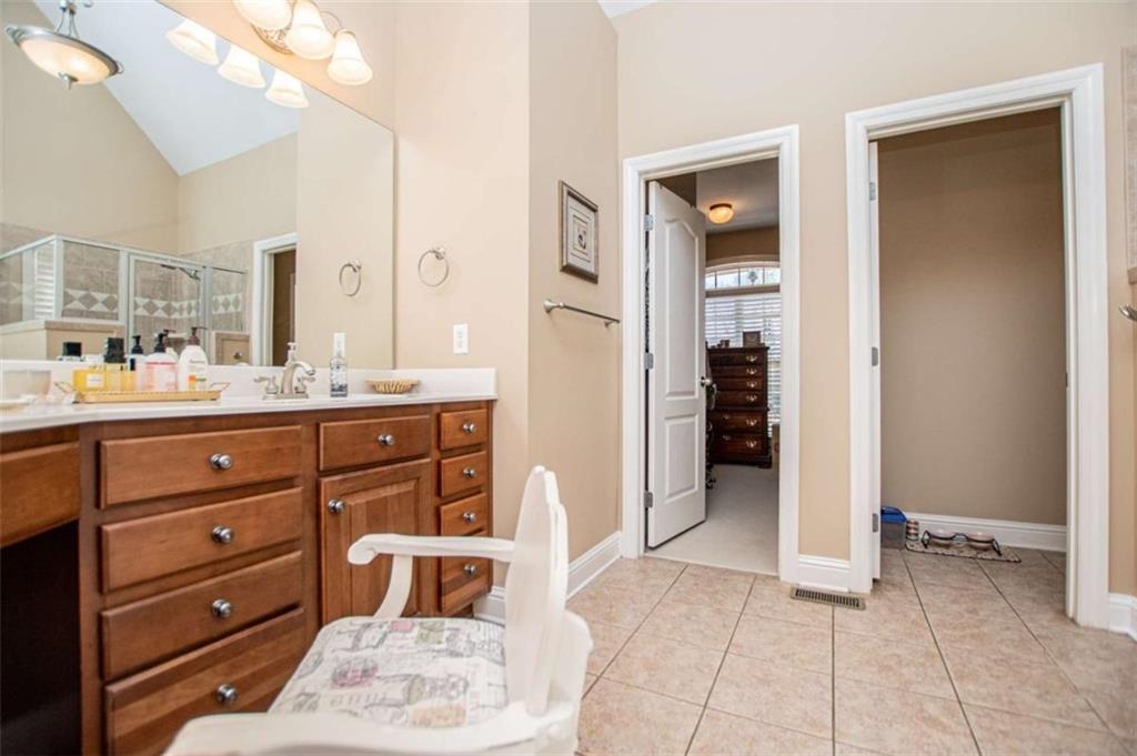 6170 Hedgestone Way Douglasville, GA 30135 - Photo 38 of 106 a room with a dresser and a mirror