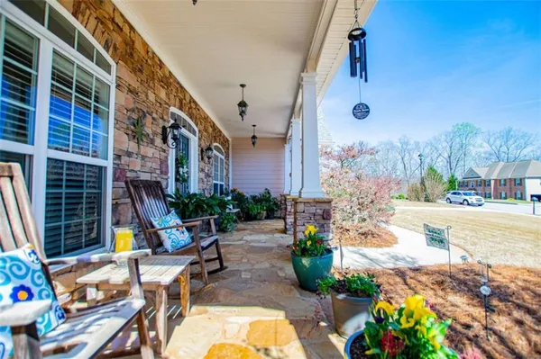 a view of a house with backyard and sitting area