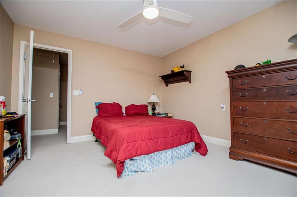 6170 Hedgestone Way Douglasville, GA 30135 - Photo 56 of 106 a bedroom with a bed and a dresser