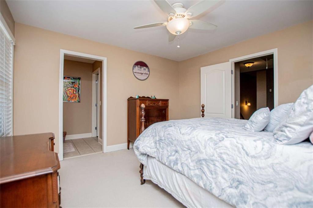 6170 Hedgestone Way Douglasville, GA 30135 - Photo 58 of 106 a bedroom with a large bed and a chandelier