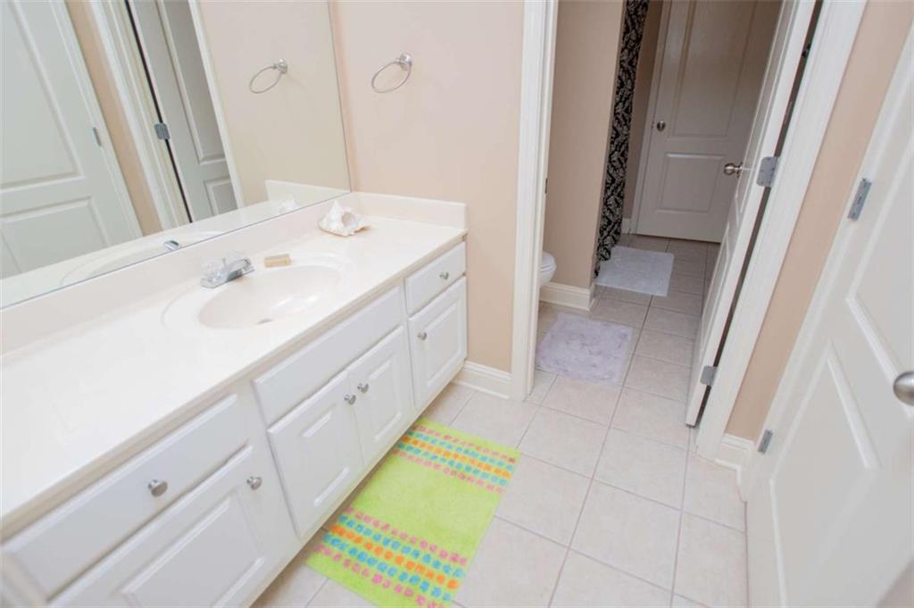 6170 Hedgestone Way Douglasville, GA 30135 - Photo 63 of 106 a spacious bathroom with a sink and a mirror