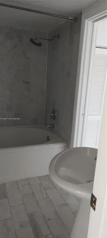 a bathroom with a tub and a window