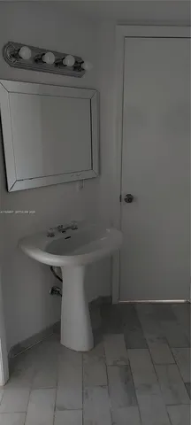 a bathroom with a sink and cabinets