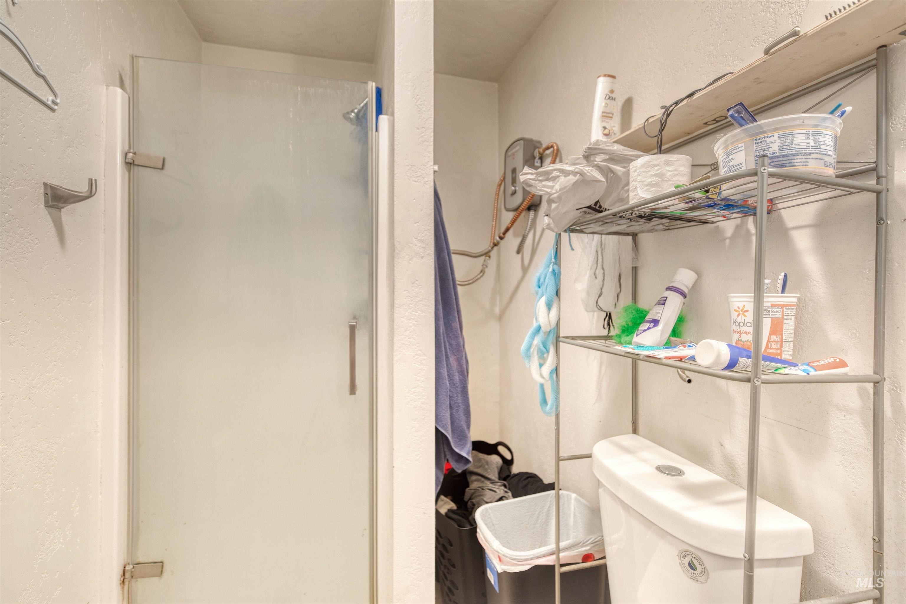 110 East Main Street Nyssa, OR 97913 - Photo 15 of 17 Bathroom featuring a stall shower and a textured wall