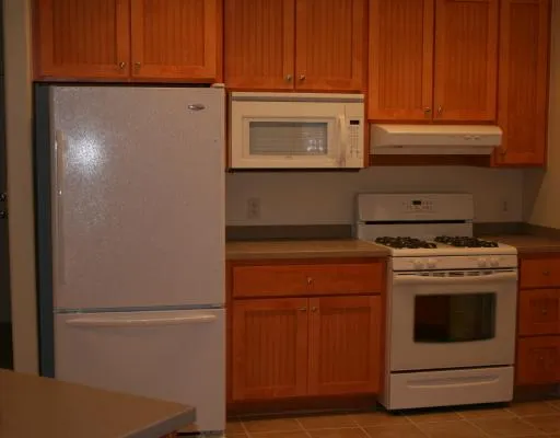 a stove top oven sitting inside of a kitchen