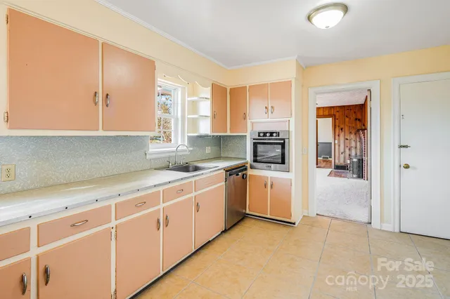 a kitchen with granite countertop white cabinets and white appliances