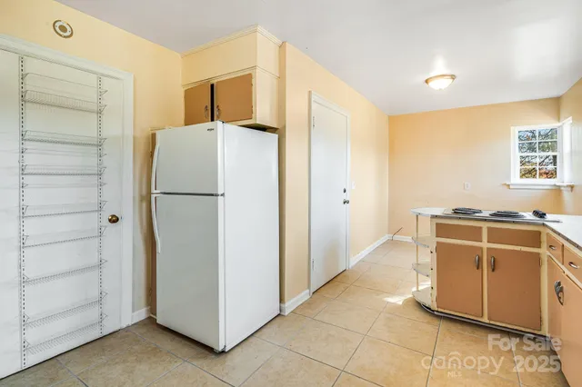 a kitchen with stainless steel appliances a refrigerator and a stove