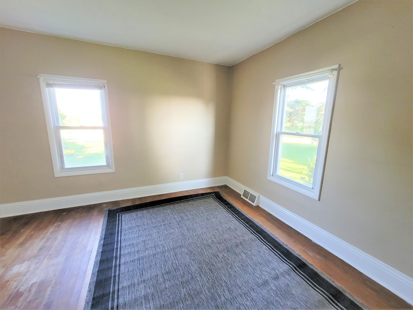 6932 Randall Road Poplar Grove, IL 61065 - Photo 16 of 44 a view of an empty room with wooden floor and a window