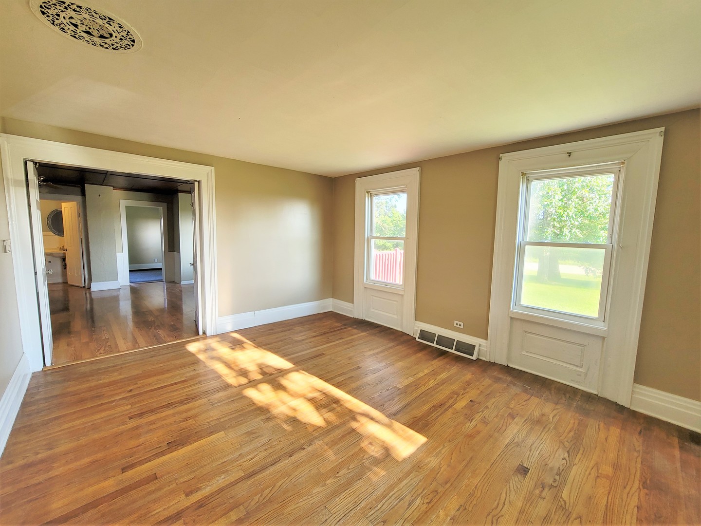 6932 Randall Road Poplar Grove, IL 61065 - Photo 8 of 44 an empty room with wooden floor and windows
