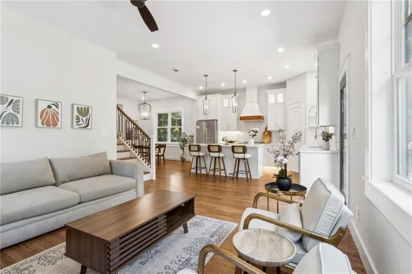 a living room with furniture and wooden floor