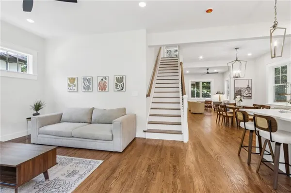 a living room with furniture and a wooden floor