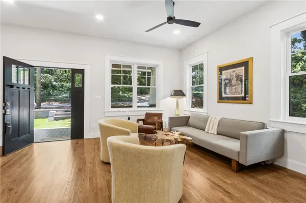 a living room with furniture and wooden floor