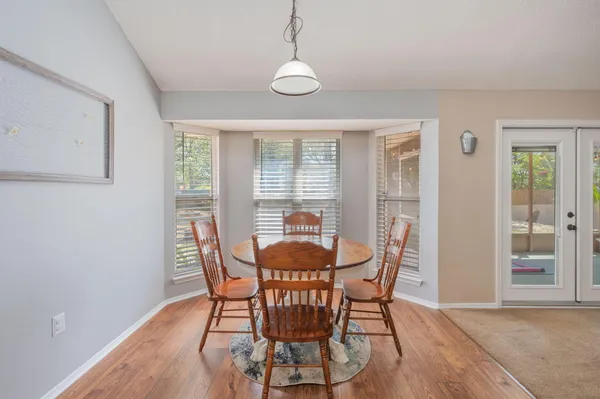 a kitchen with cabinets and wooden floor