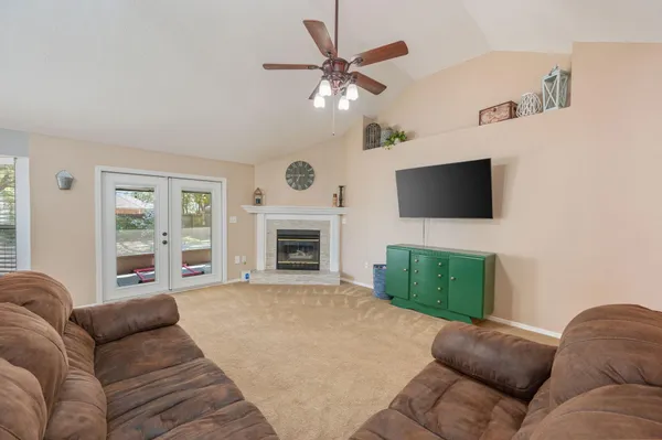 a living room with furniture and a chandelier