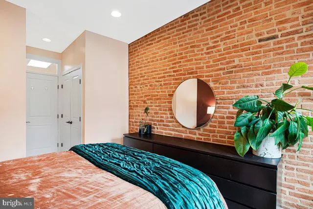 a bedroom with a bed and a lamp