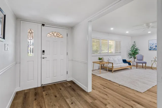 a living room with furniture and a potted plant