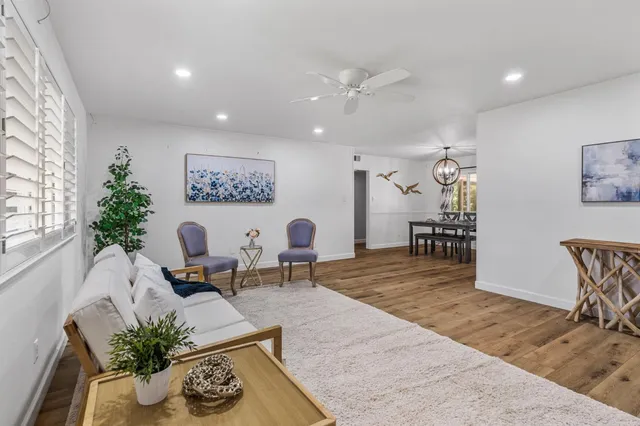 a view of a dining room with furniture window and wooden floor
