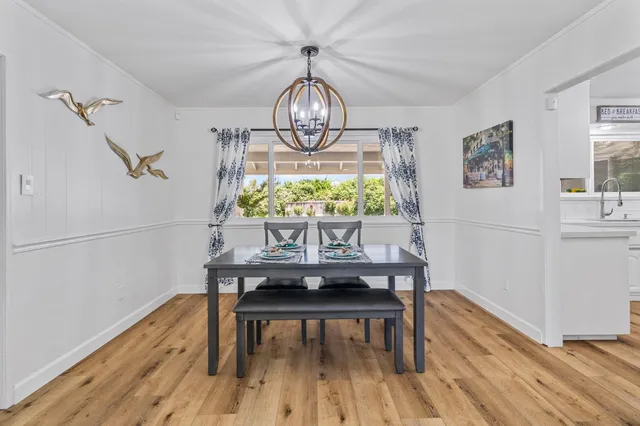 a view of a room with wooden floor cabinetry and windows
