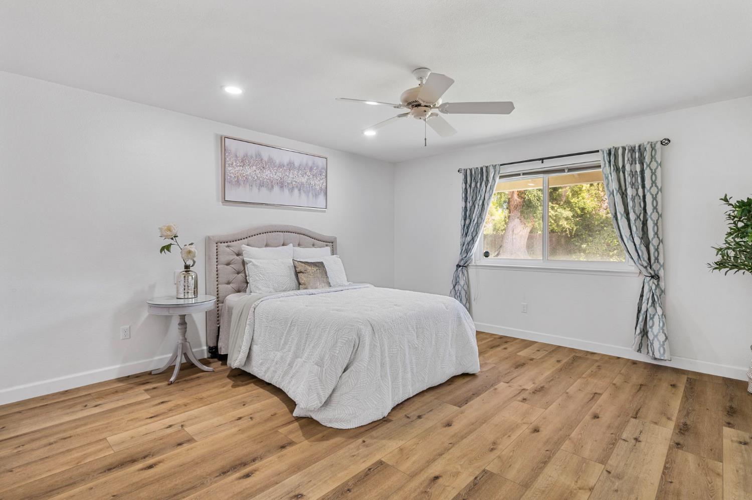 2433 Broadridge Way Stockton, CA 95209 - Photo 19 of 67 a bedroom with a bed and wooden floor