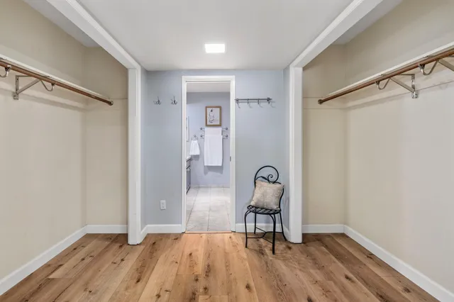 a kitchen with stainless steel appliances granite countertop white cabinets and a stove a oven with white countertops
