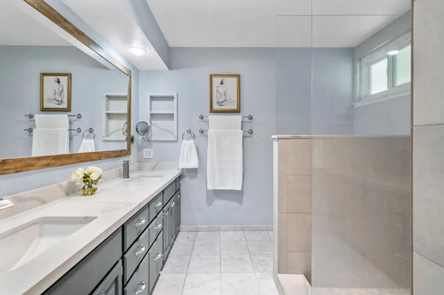 a kitchen with stainless steel appliances white cabinets and a window