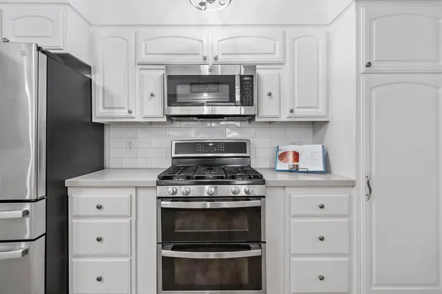 a spacious bedroom with a bed and a table