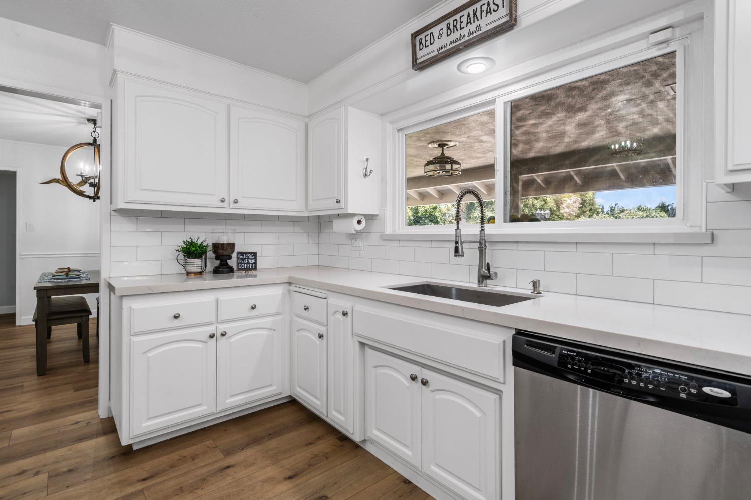 2433 Broadridge Way Stockton, CA 95209 - Photo 30 of 67 a kitchen with stainless steel appliances white cabinets and a window