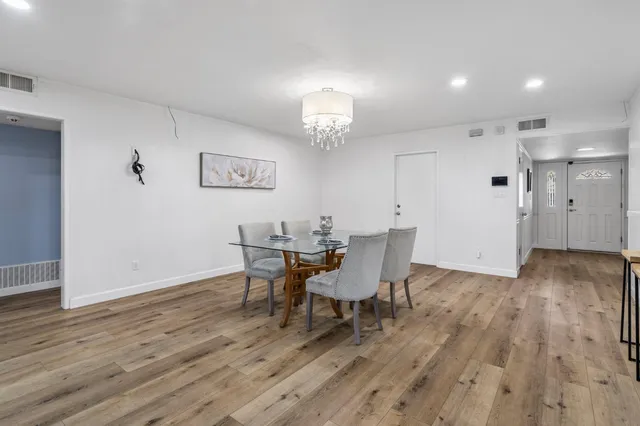 a view of a patio with a table chairs and floor to ceiling window