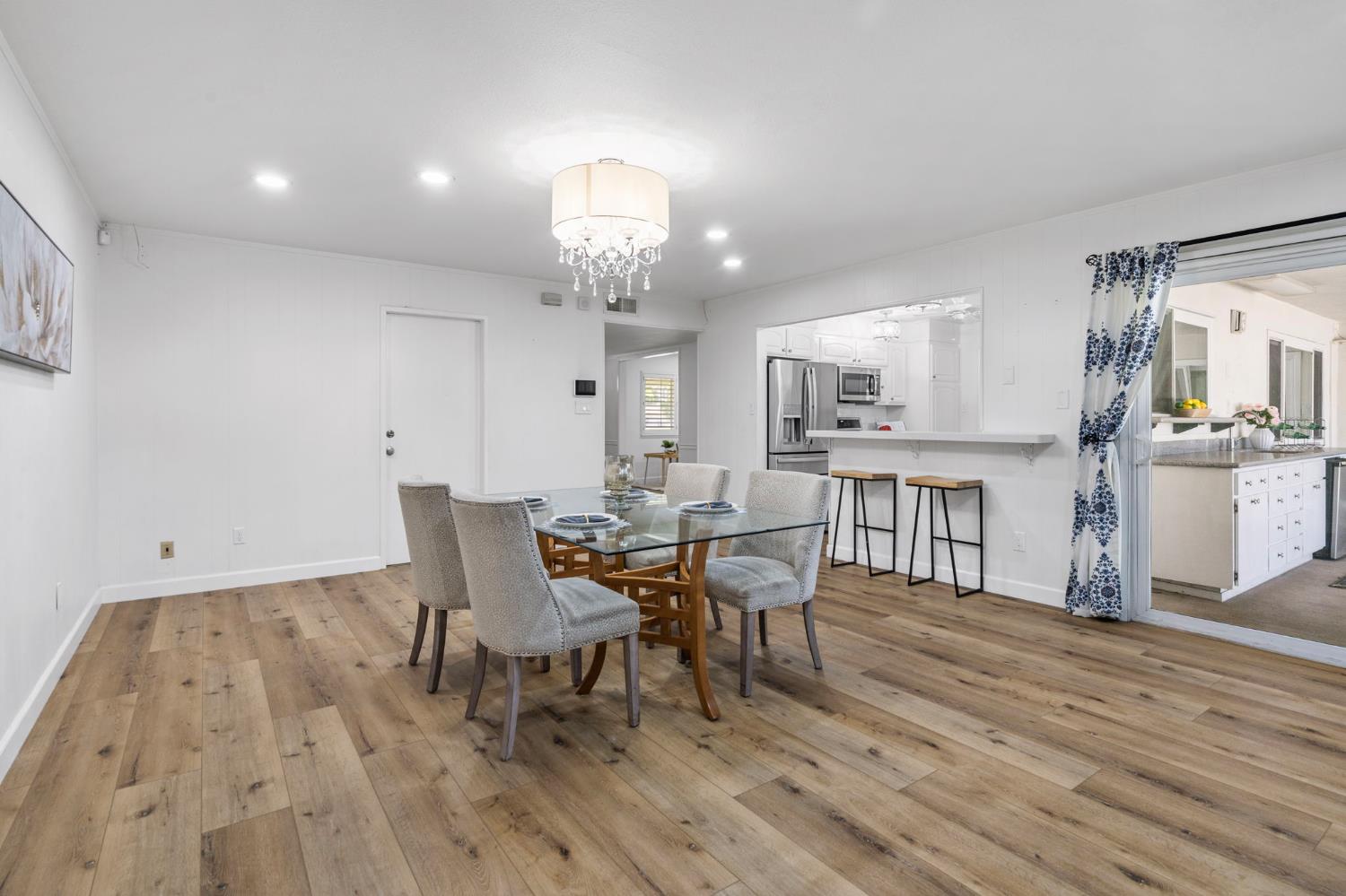 2433 Broadridge Way Stockton, CA 95209 - Photo 34 of 67 a view of a dining room with furniture and wooden floor