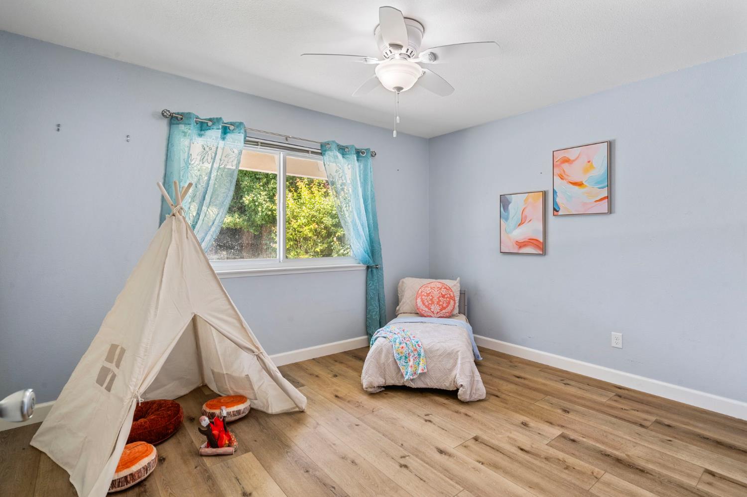 2433 Broadridge Way Stockton, CA 95209 - Photo 40 of 67 a room with wooden floor and a ceiling fan