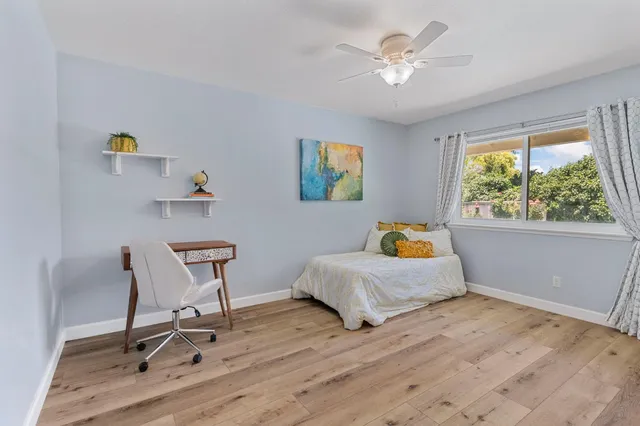 a house with green field in front of it