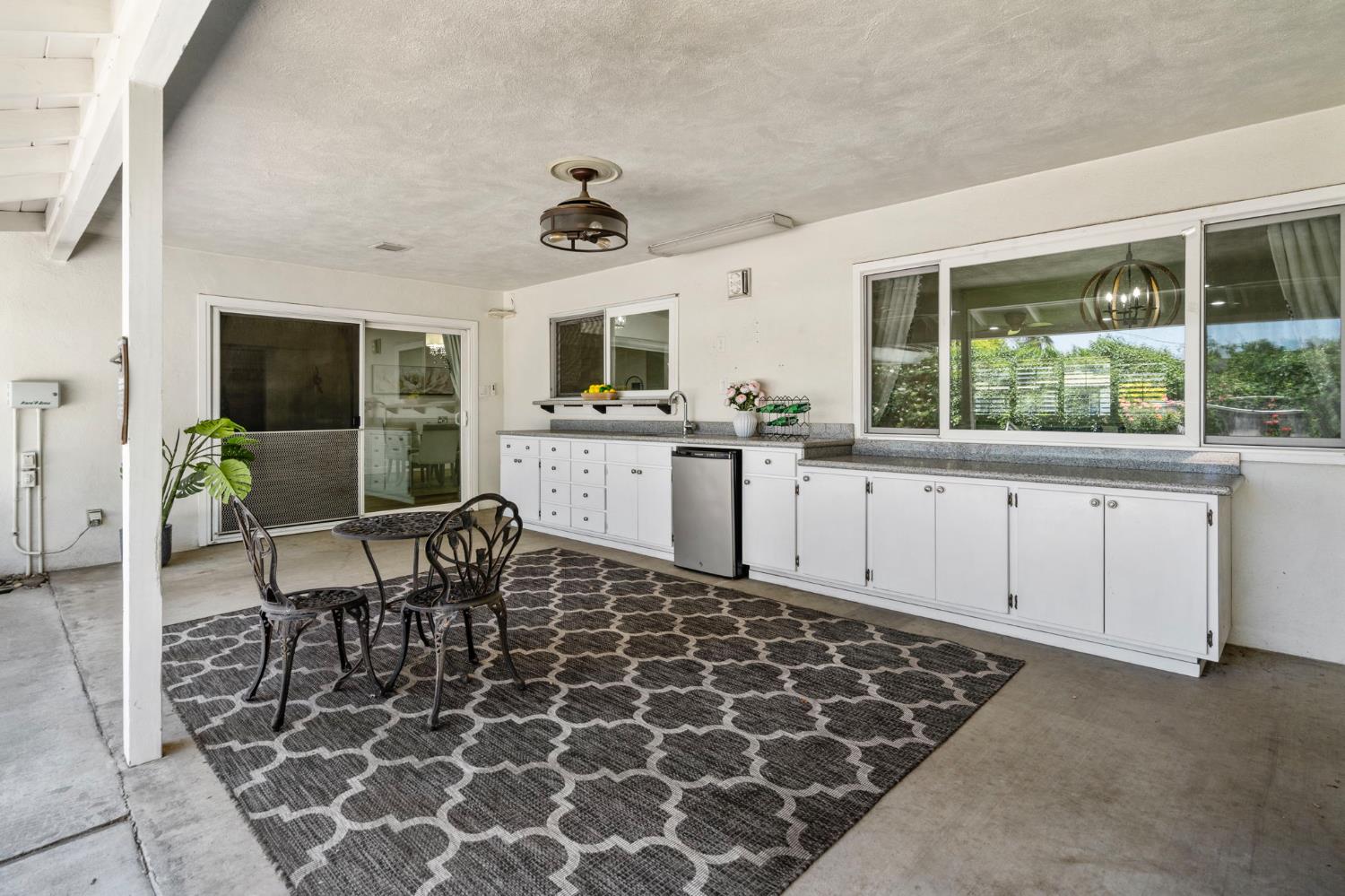 2433 Broadridge Way Stockton, CA 95209 - Photo 44 of 67 a living room with furniture a flat screen tv and a table