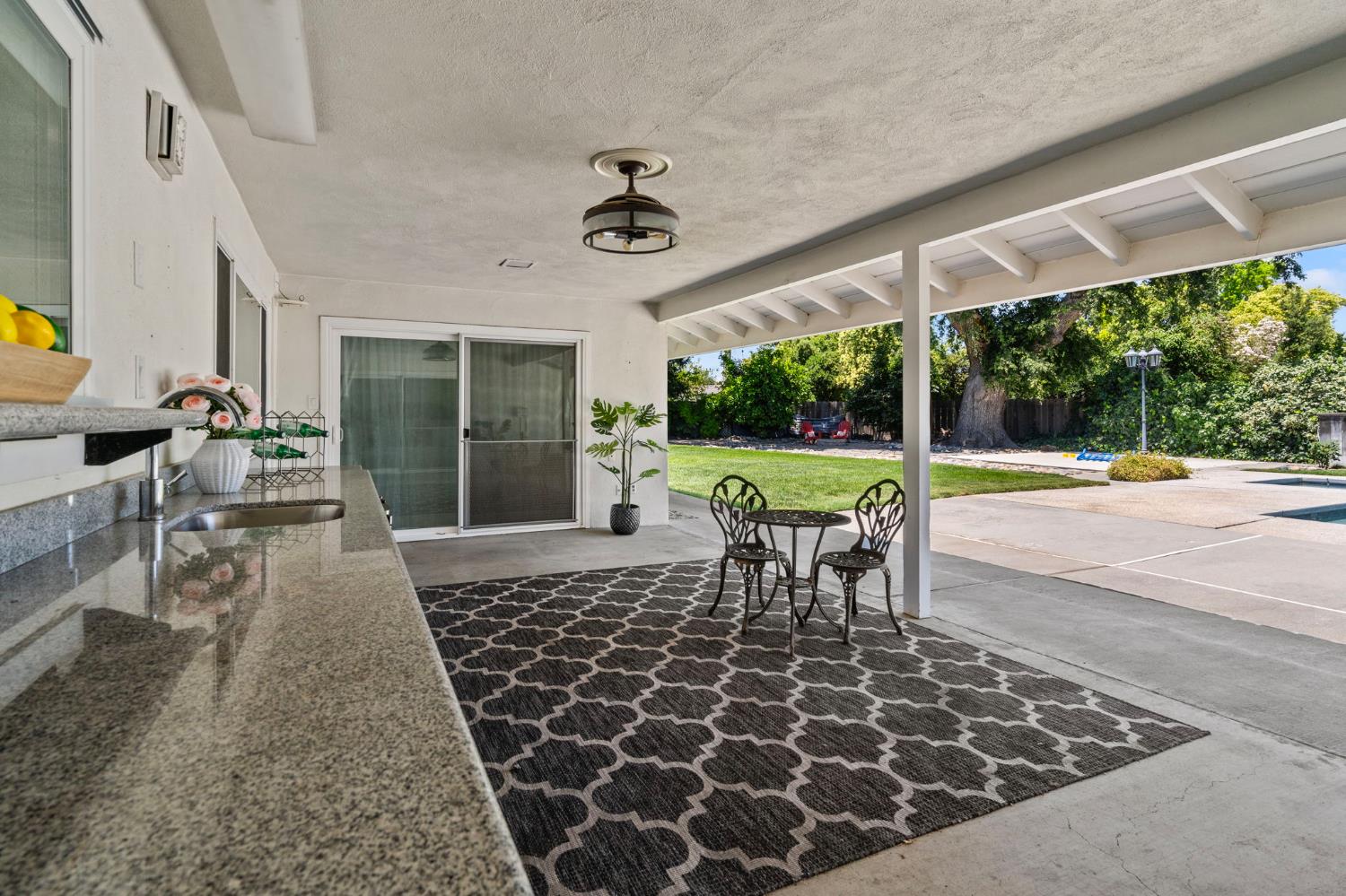 2433 Broadridge Way Stockton, CA 95209 - Photo 46 of 67 a view of a patio with a table chairs and floor to ceiling window