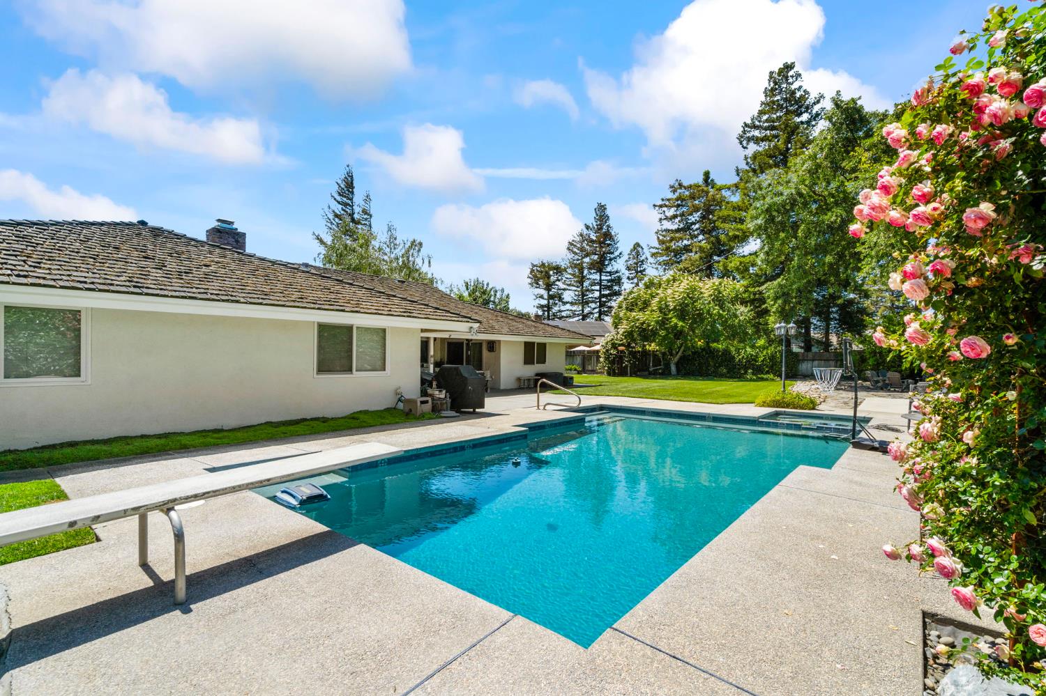 2433 Broadridge Way Stockton, CA 95209 - Photo 52 of 67 a view of a house with swimming pool and a yard