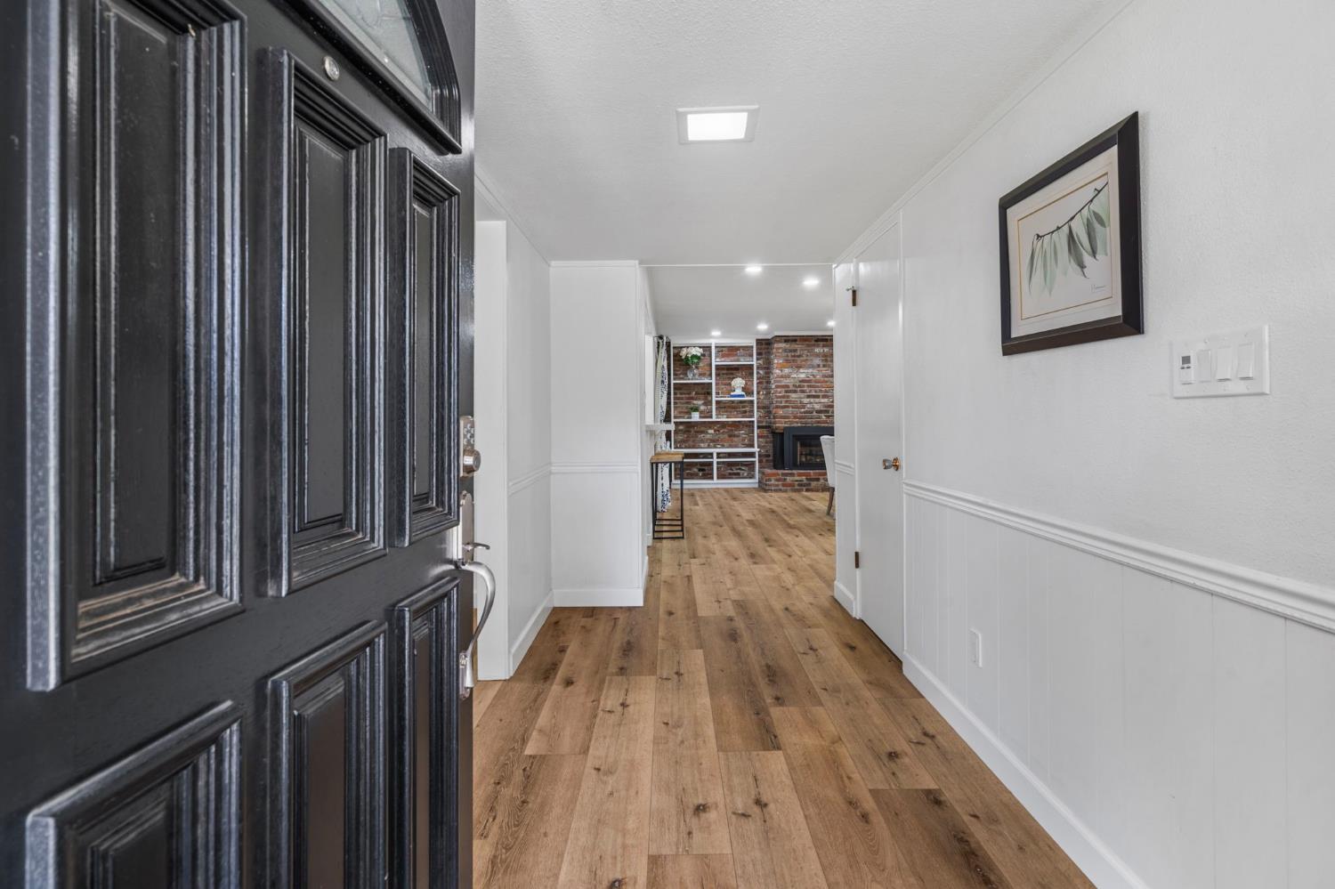 2433 Broadridge Way Stockton, CA 95209 - Photo 10 of 67 a view of a hallway with wooden floor and staircase