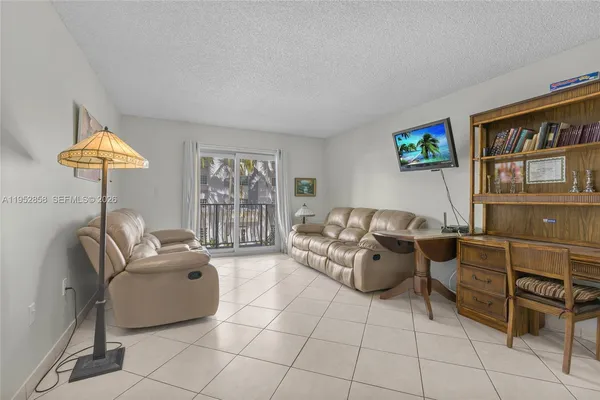 a view of a livingroom with table and chairs